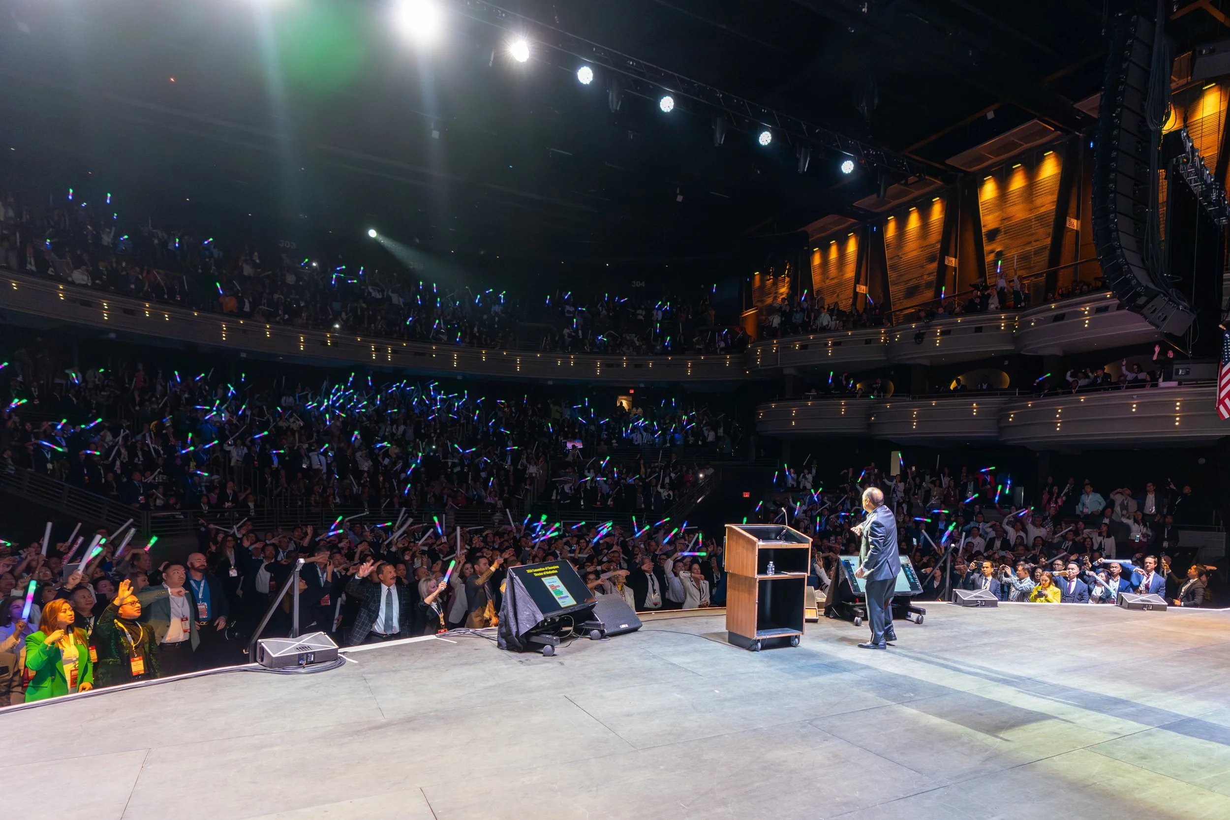 Convention audience with glow sticks at a Las Vegas keynote